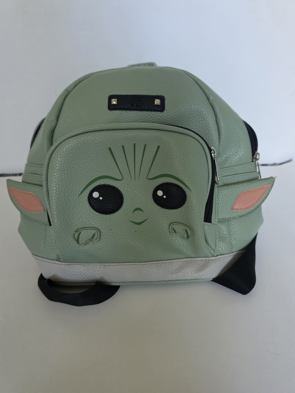 a green Star Wars Grogu Mini Backpack featuring a character face
